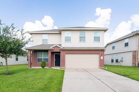 a house with a driveway and a garage door