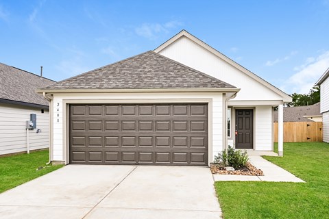 a garage with a driveway in front of a house