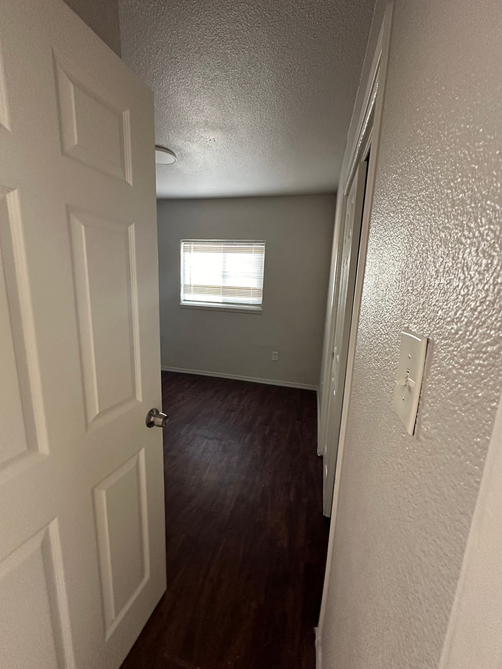 a room with a door and a window and a hallway