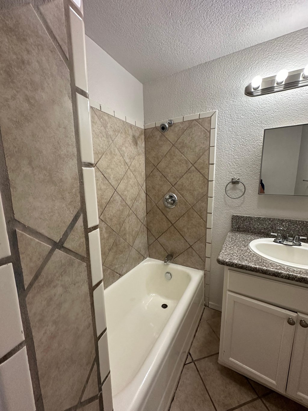 a bathroom with a tub and a sink and a mirror