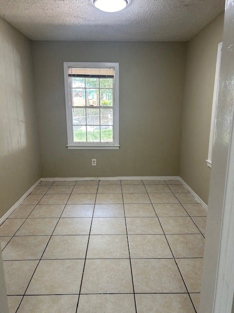 an empty room with a window and a tiled floor