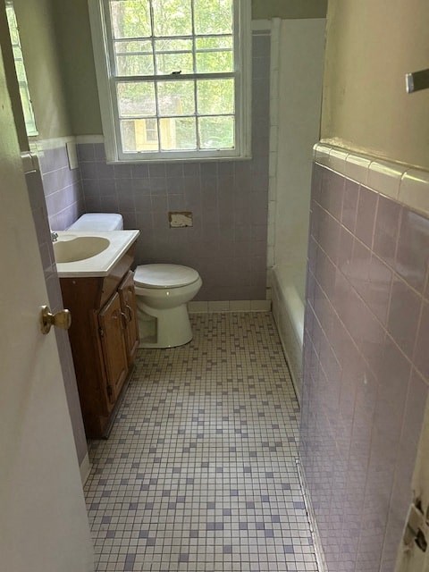 a bathroom with a toilet and a sink and a window