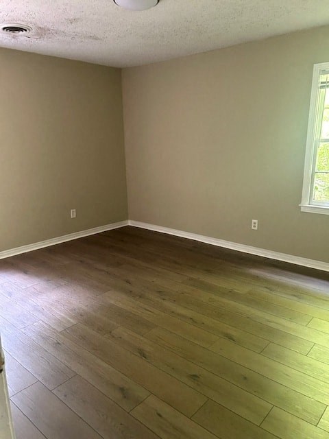 an empty living room with wooden floors