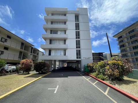 A white building with a red line on the ground in front of it.