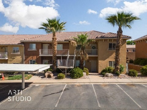 an apartment building with palm trees in front of it