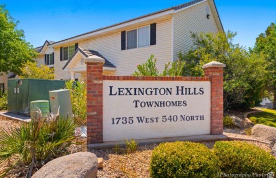 a sign townhomes in front of a house