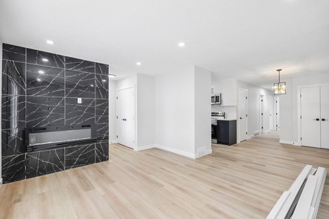 a living room with a fireplace and a wooden floor