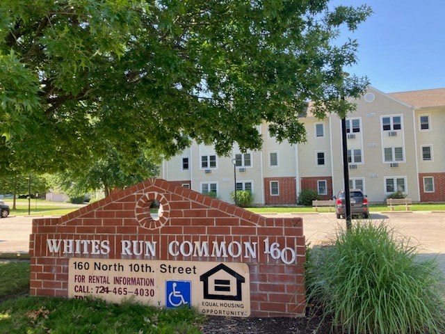 a sign for the white run common 160 in front of an apartment building