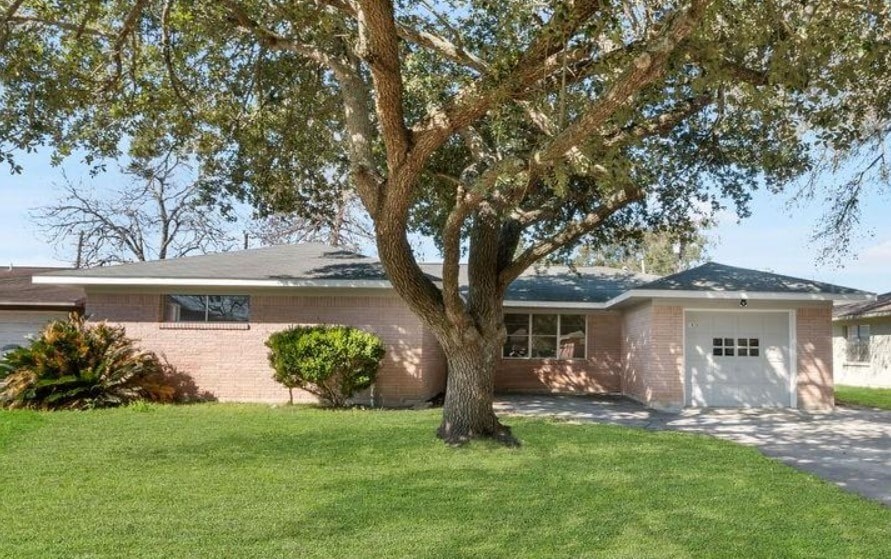 A house with a tree in front of it.