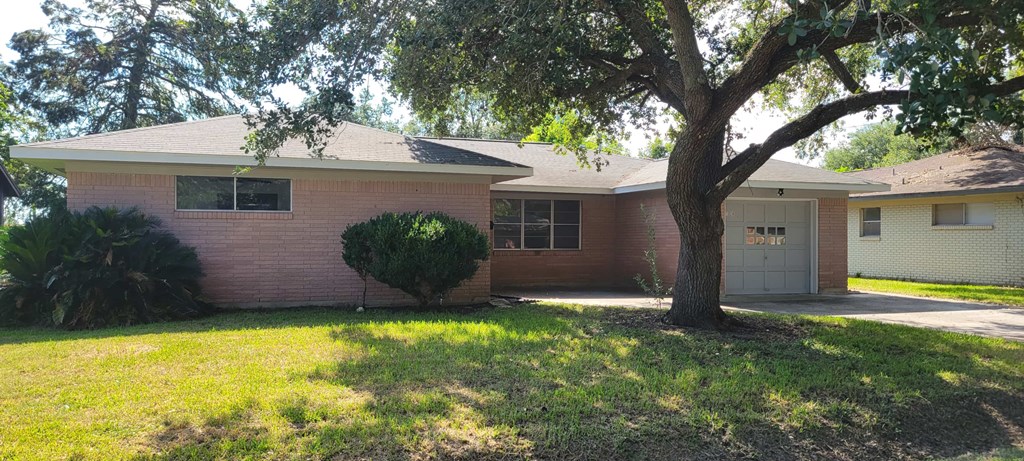 A house with a tree in front of it.