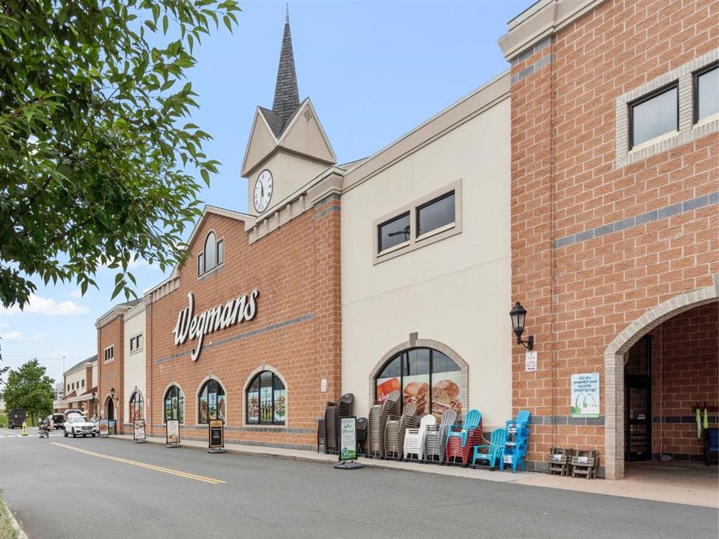 a shopping mall with a clock tower on the side of a building