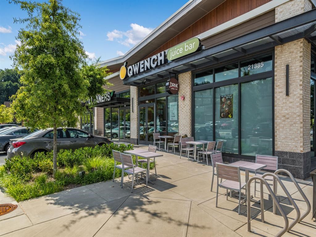 a patio outside of a restaurant with tables and chairs