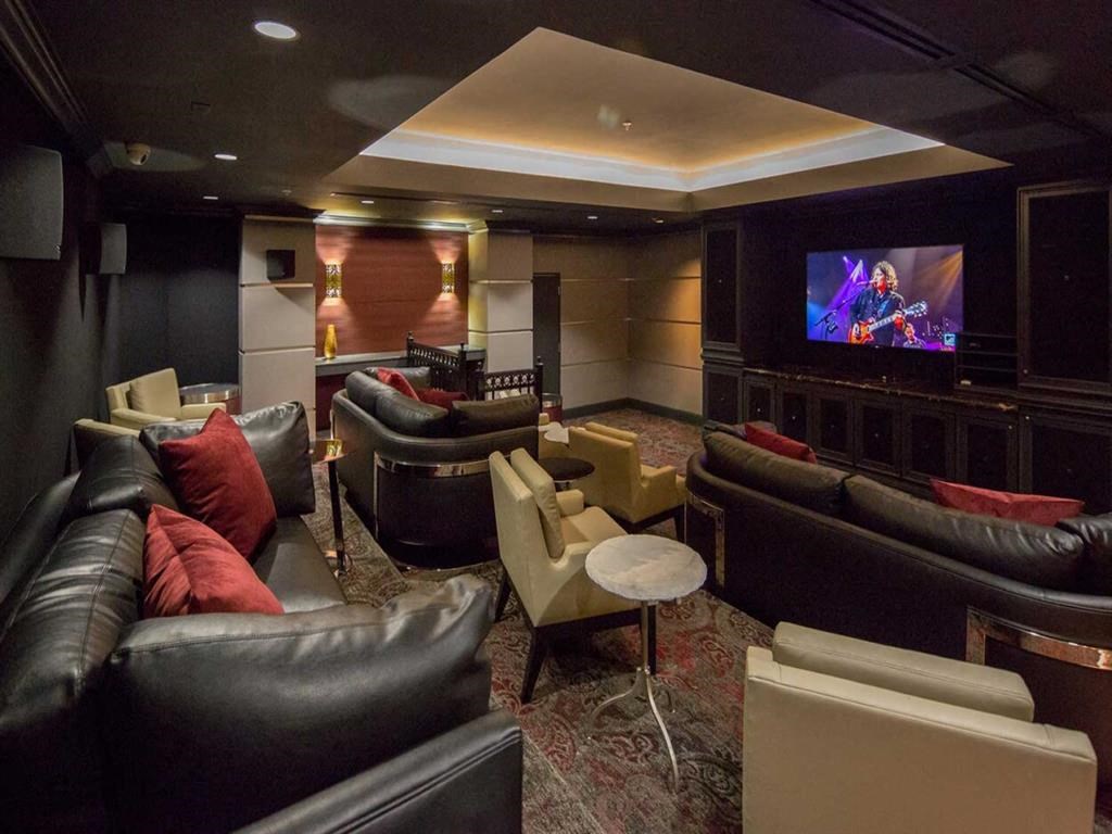 a living room with couches and chairs and a television