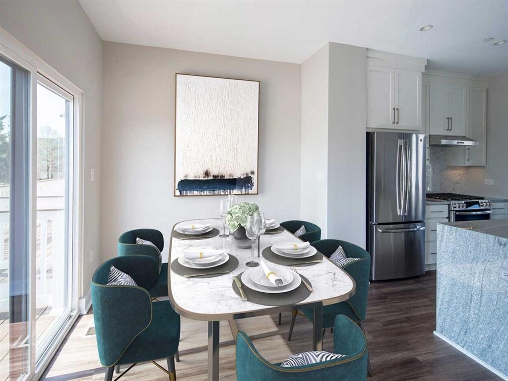 a kitchen and dining room with a table and chairs