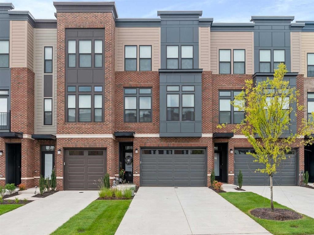 a red brick building with two garage doors