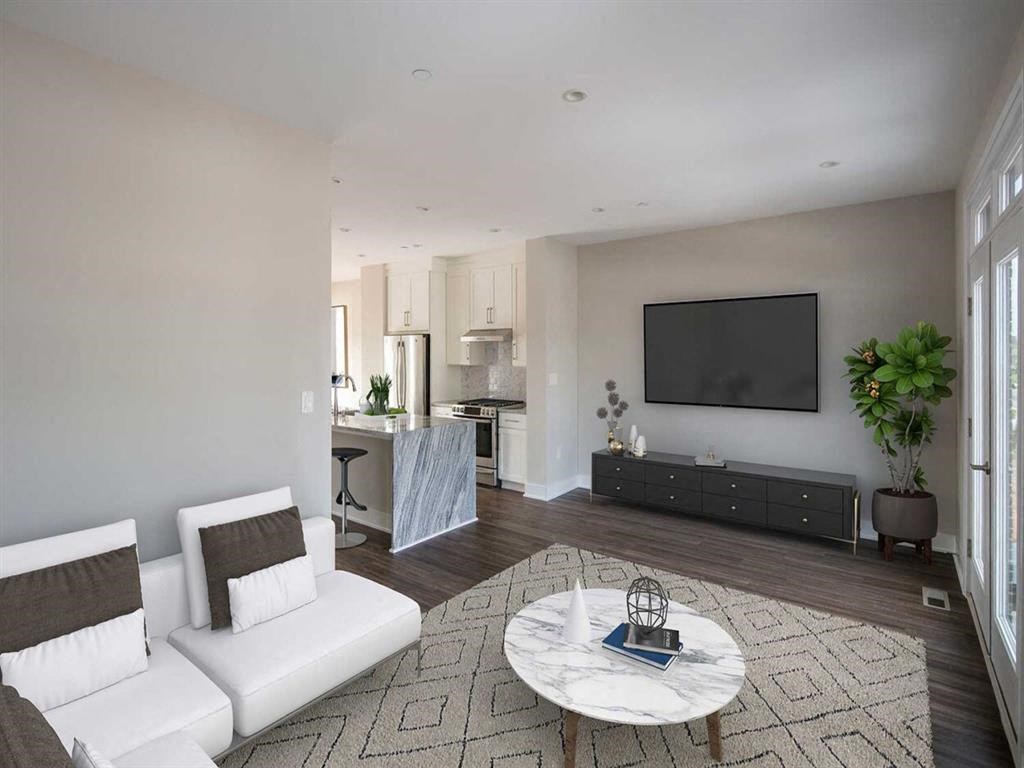 a white living room with a white couch and a table