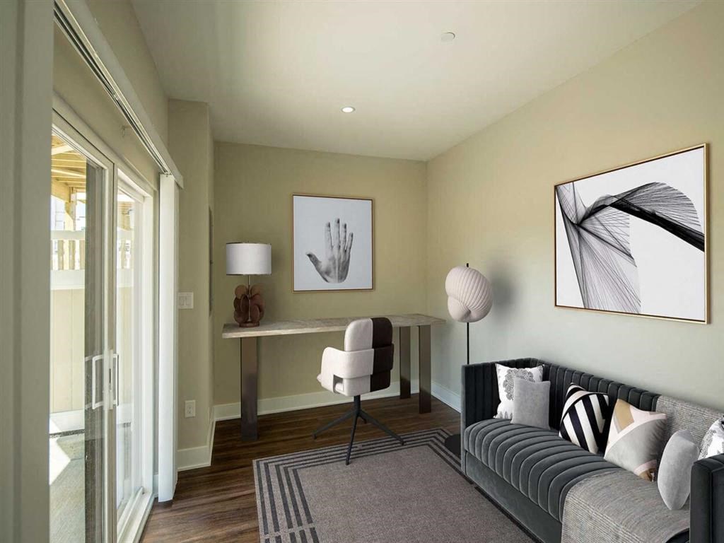 a living room with a couch and a desk