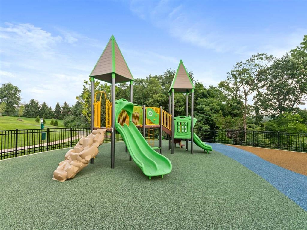 a playground with slides and other toys in a park