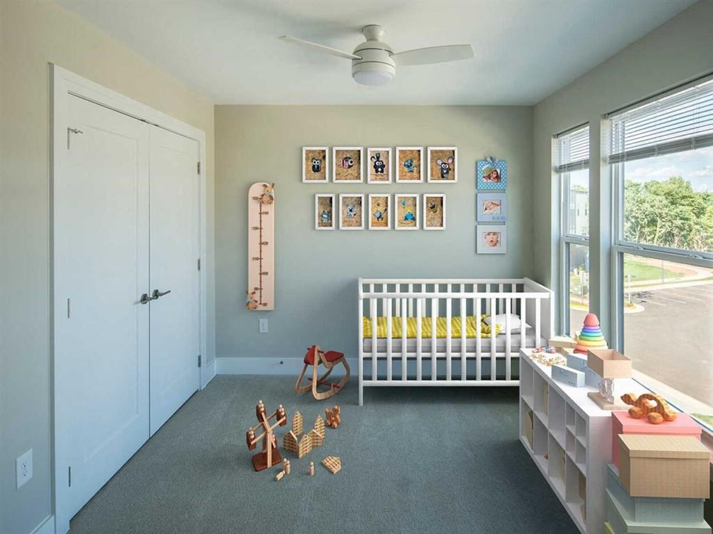 a nursery with a crib and toys in the floor