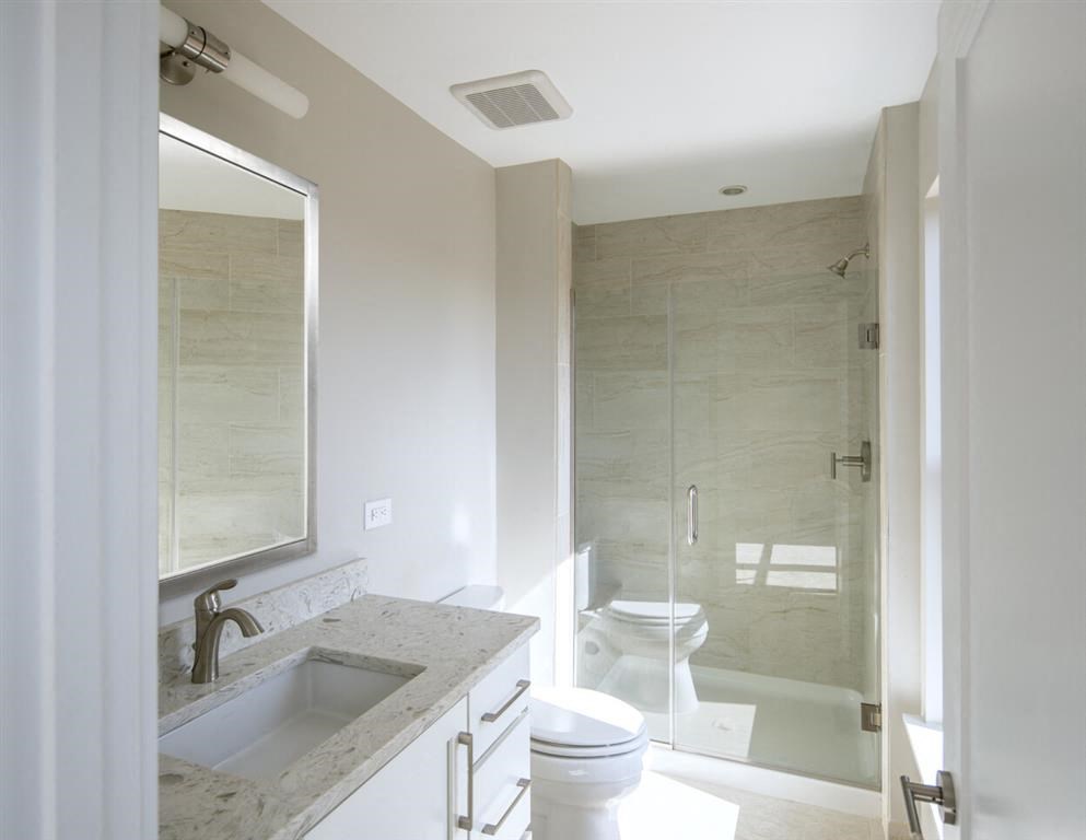 a bathroom with a sink toilet and a shower