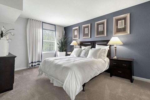 bedroom with blue walls and a white bed