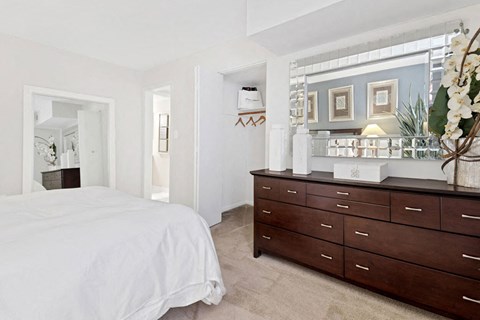 a bedroom with a bed and a dresser