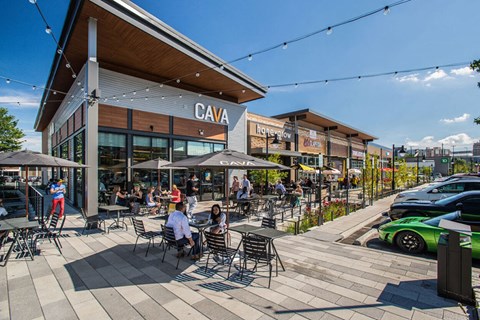 a rendering of people sitting at tables outside of a restaurant
