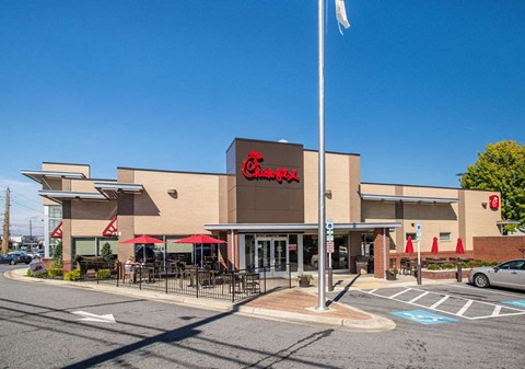 the facade of a grocery store with a flag in front