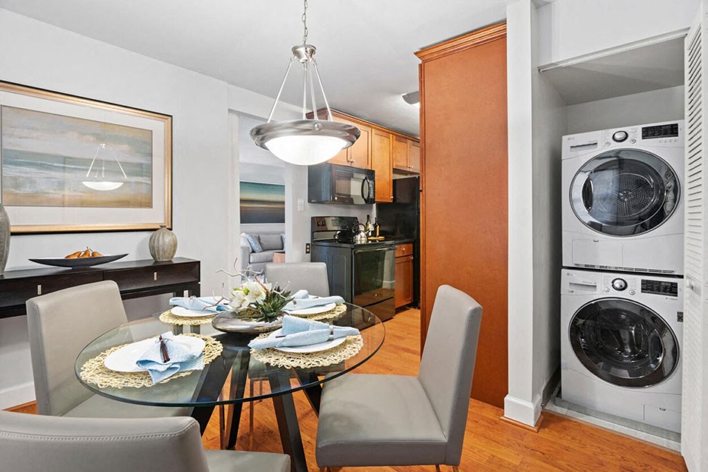 a dining room with a table and chairs and a washing machine