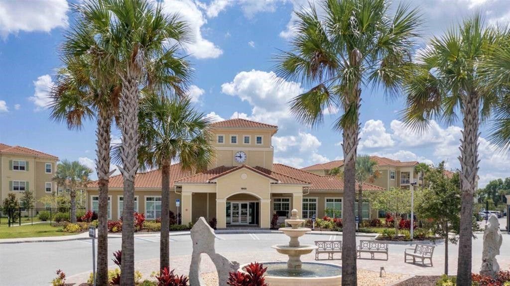 a courtyard with a fountain and palm trees in front of a building