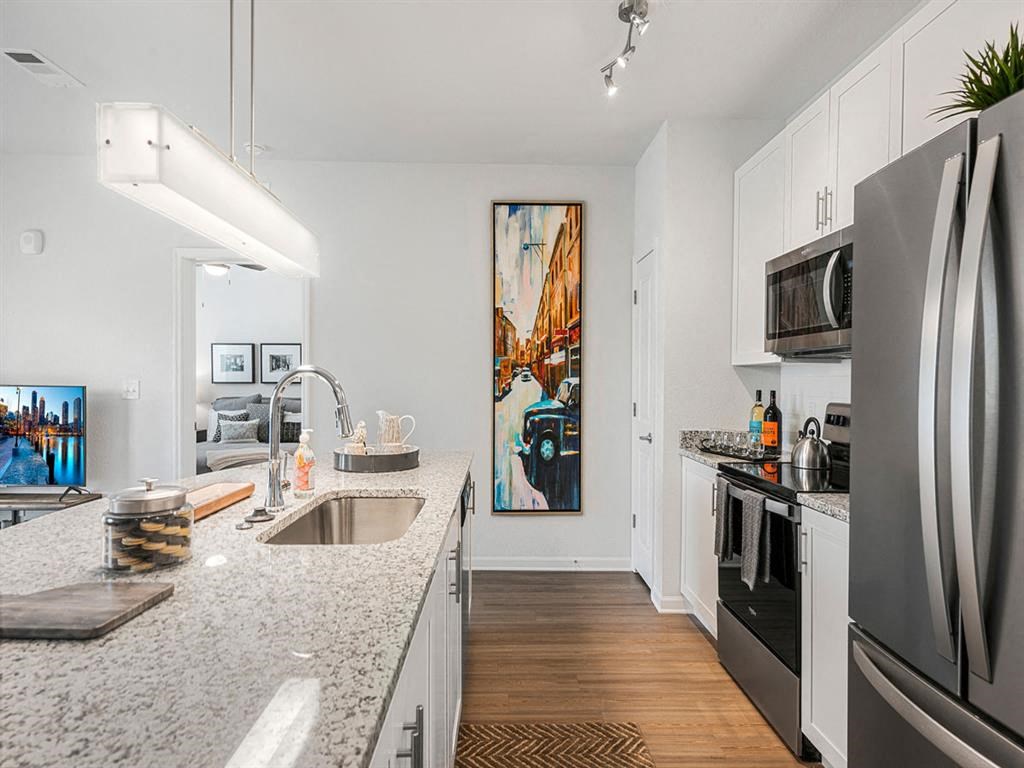 a kitchen with granite counter tops and stainless steel appliances