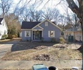 a blue house with a yard in front of it