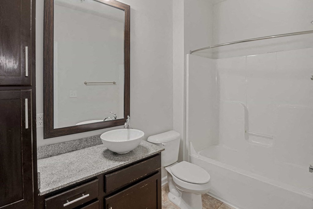A bathroom with a toilet, sink, and bathtub.