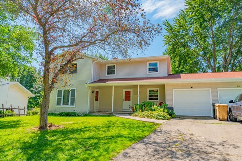 A house with a tree in front of it.