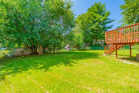 A backyard with a wooden structure and trees.