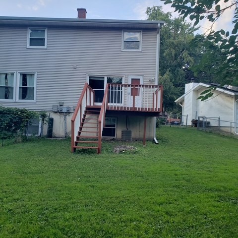 A house with a red and white deck.