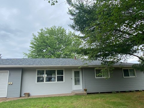 A house with a grey roof and a white door.