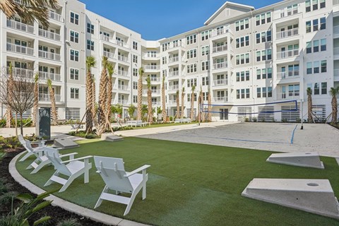 A white building with a green lawn in front.