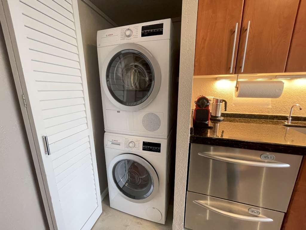 A white washing machine and dryer in a small laundry room.