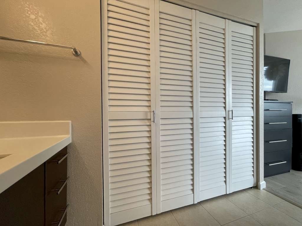 Closed white shutter doors in a room.