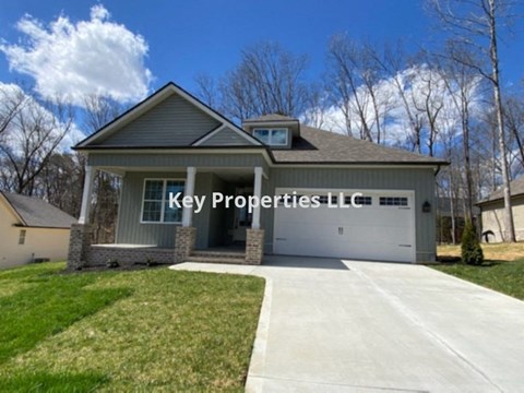 A house with the words Key Properties LLC on the side.