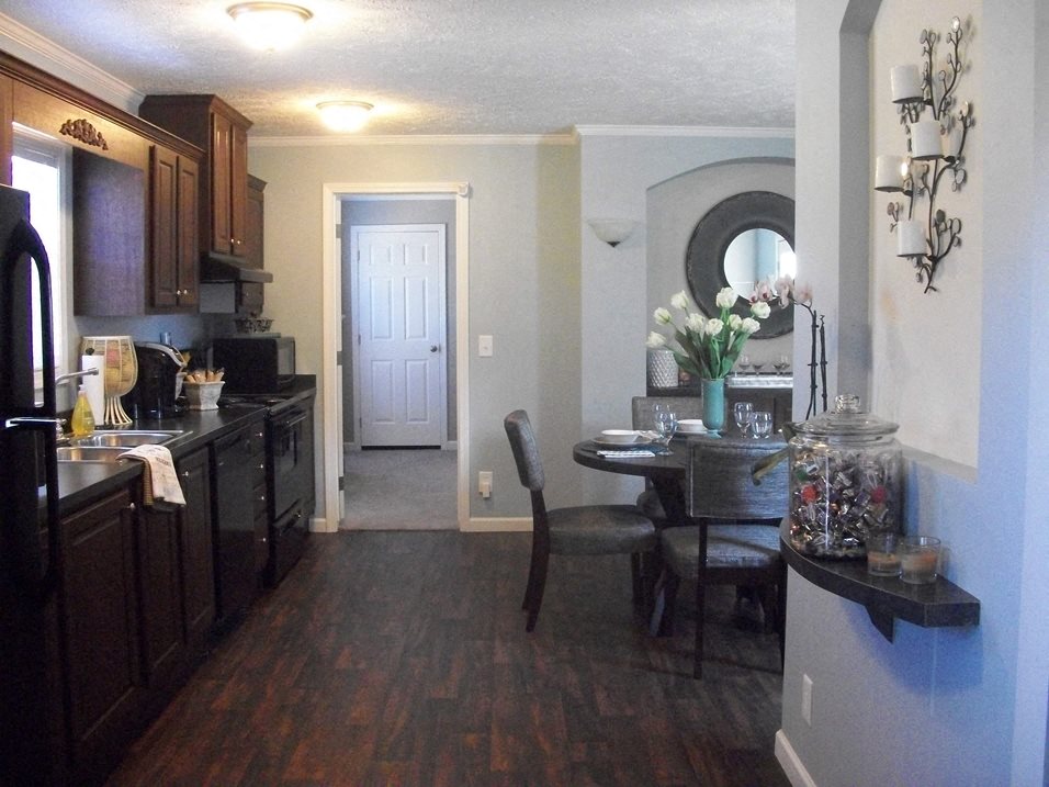 a kitchen and dining room with a table and chairs