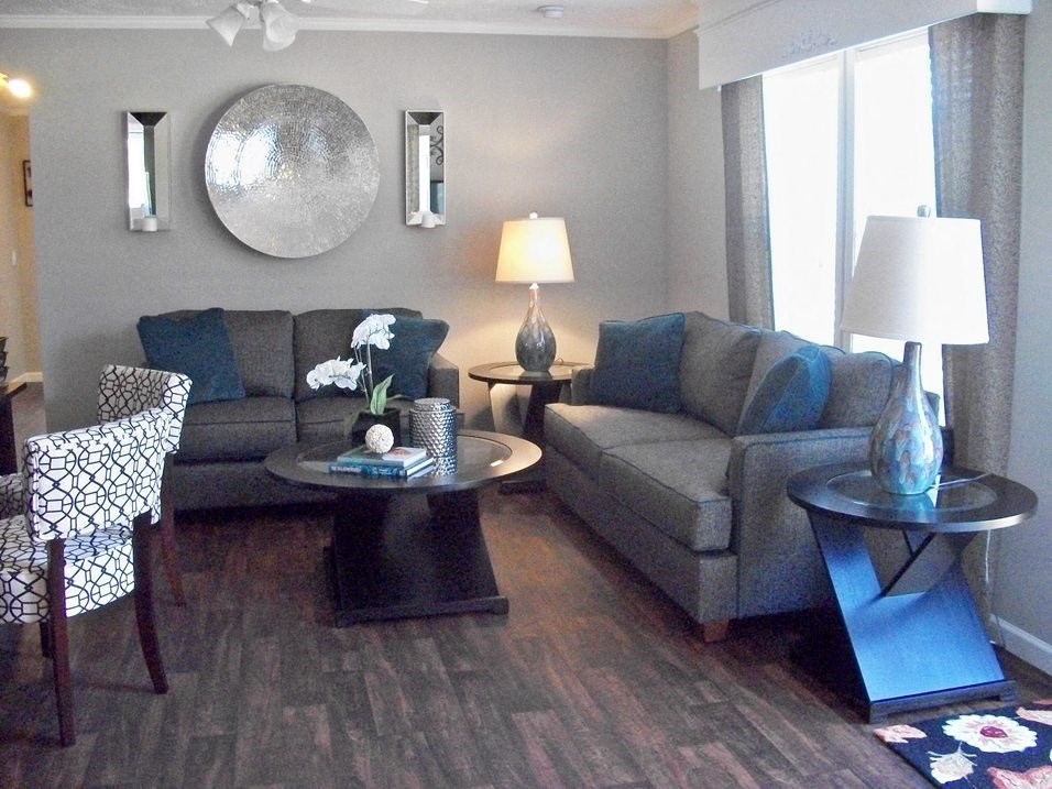a living room with couches and chairs and a table