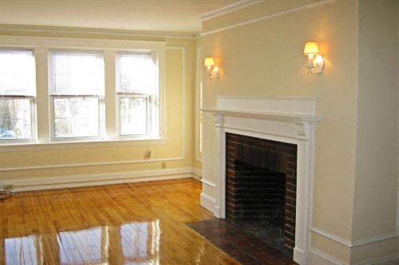 a living room with a fireplace and a wooden floor