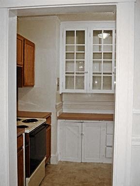 a small kitchen with a stove and a window