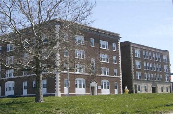 a large brick building with a tree in front of it