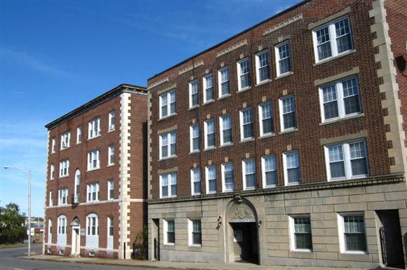 a large brick building on the side of a street