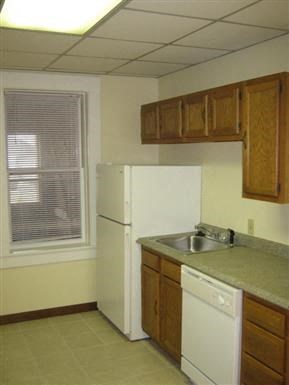 a kitchen with a sink and a refrigerator