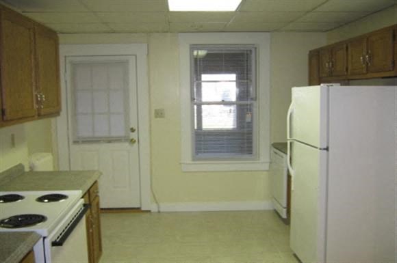 a kitchen with a stove and a refrigerator