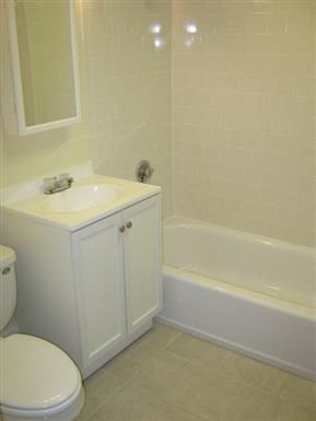 a bathroom with a toilet and a tub and a sink